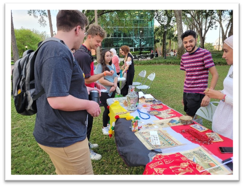 Students visit an international festival culture table.